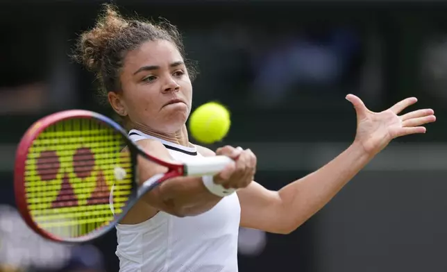 Jasmine Paolini of Italy plays a forehand return to Donna Vekic of Croatia during their semifinal match at the Wimbledon tennis championships in London, Thursday, July 11, 2024. (AP Photo/Alberto Pezzali)