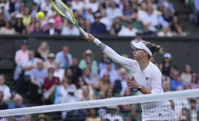 Barbora Krejcikova of the Czech Republic plays a forehand return to Elena Rybakina of Kazakhstan during their semifinal match at the Wimbledon tennis championships in London, Thursday, July 11, 2024. (AP Photo/Alberto Pezzali)