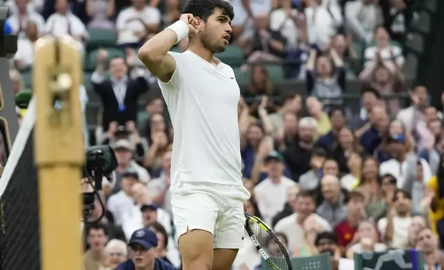 Carlos Alcaraz of Spain reacts during his quarterfinal match against Tommy Paul of the United States at the Wimbledon tennis championships in London, Tuesday, July 9, 2024. (AP Photo/Kirsty Wigglesworth)