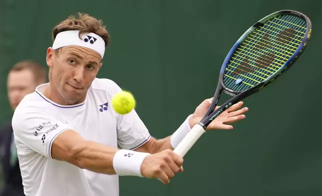 Casper Ruud of Norway plays a backhand return to Alex Bolt of Australia during their first round match of the Wimbledon tennis championships in London, Monday, July 1, 2024. (AP Photo/Alberto Pezzali)