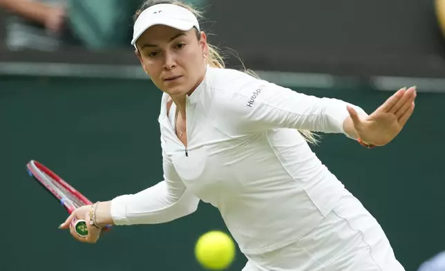 Donna Vekic of Croatia plays a forehand return to Lulu Sun of New Zealand during their quarterfinal match at the Wimbledon tennis championships in London, Tuesday, July 9, 2024. (AP Photo/Mosa'ab Elshamy)