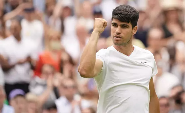 Carlos Alcaraz of Spain reacts after defeating Mark Lajal of Estonia in their first round match of the Wimbledon tennis championships in London, Monday, July 1, 2024. (AP Photo/Alberto Pezzali)