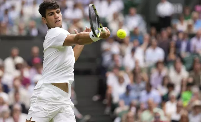 Carlos Alcaraz of Spain plays a forehand return to Mark Lajal of Estonia during their first round match of the Wimbledon tennis championships in London, Monday, July 1, 2024. (AP Photo/Alberto Pezzali)