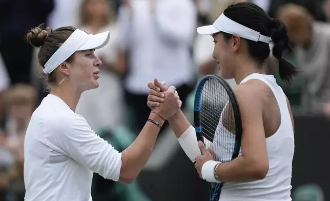 Elina Svitolina of Ukraine is congratulated by Xinyu Wang, right, of China following their fourth round match at the Wimbledon tennis championships in London, Monday, July 8, 2024. (AP Photo/Mosa'ab Elshamy)