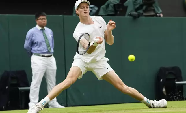 Jannik Sinner of Italy plays a forehand return to Daniil Medvedev of Russia during their quarterfinal match at the Wimbledon tennis championships in London, Tuesday, July 9, 2024. (AP Photo/Alberto Pezzali)