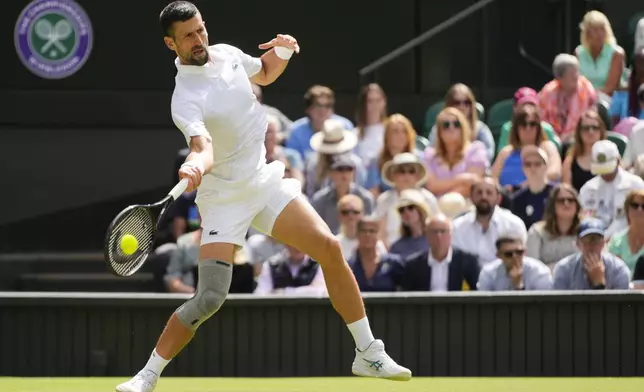 Serbia's Novak Djokovic plays a forehand return to Britain's Jacob Fearnley during their second round match at the Wimbledon tennis championships in London, Thursday, July 4, 2024. (AP Photo/Kirsty Wigglesworth)