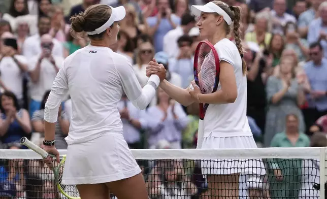 Barbora Krejcikova, left, of the Czech Republic is congratulated by Elena Rybakina of Kazakhstan following their semifinal match at the Wimbledon tennis championships in London, Thursday, July 11, 2024. (AP Photo/Alberto Pezzali)
