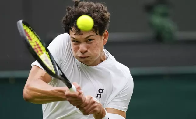 Ben Shelton of the United States plays a backhand return to Jannik Sinner of Italy during their fourth round match at the Wimbledon tennis championships in London, Sunday, July 7, 2024. (AP Photo/Kirsty Wigglesworth)