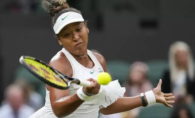 Naomi Osaka of Japan plays a forehand return to Emma Navarro of the United States during their match on day three at the Wimbledon tennis championships in London, Wednesday, July 3, 2024. (AP Photo/Alberto Pezzali)