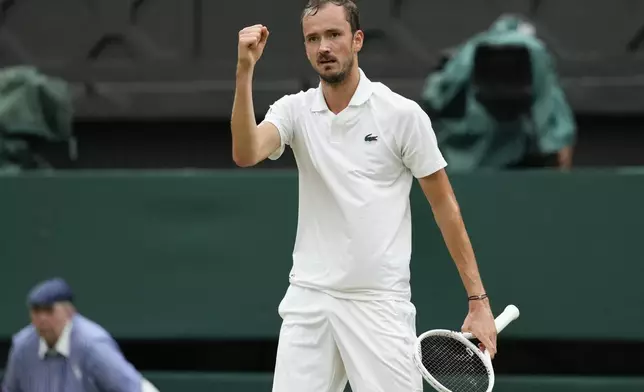 Daniil Medvedev of Russia reacts after winning a point against Jannik Sinner of Italy during their quarterfinal match at the Wimbledon tennis championships in London, Tuesday, July 9, 2024. (AP Photo/Alberto Pezzali)