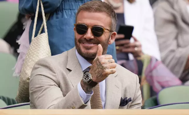 David Beckham gestures as watches the first round match on Centre Court between defending champion Carlos Alcaraz of Spain and Mark Lajal of Estonia at the Wimbledon tennis championships in London, Monday, July 1, 2024. (AP Photo/Alberto Pezzali)