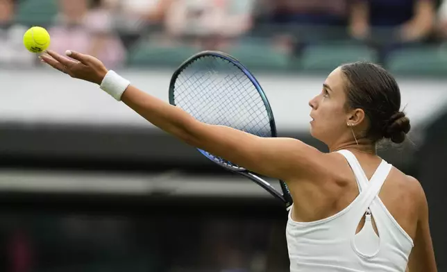 Anca Todoni of Romania serves to Coco Gauff of the United States during their match on day three at the Wimbledon tennis championships in London, Wednesday, July 3, 2024. (AP Photo/Mosa'ab Elshamy)
