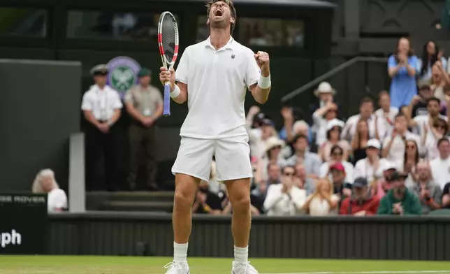 Cameron Norrie of Britain reacts after winning a point against Alexander Zverev of Germany during their third round match at the Wimbledon tennis championships in London, Saturday, July 6, 2024. (AP Photo/Kirsty Wigglesworth)