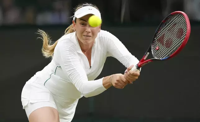 Donna Vekic of Croatia plays a backhand return to Dayana Yastremska of Ukraine during their third round match at the Wimbledon tennis championships in London, Friday, July 5, 2024. (AP Photo/Kirsty Wigglesworth)