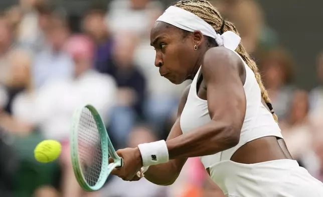 Coco Gauff of the United States plays a backhand return to Anca Todoni of Romania during their match on day three at the Wimbledon tennis championships in London, Wednesday, July 3, 2024. (AP Photo/Mosa'ab Elshamy)