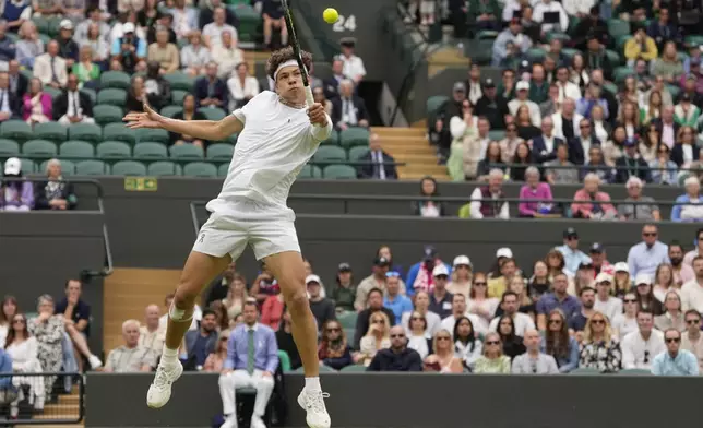 Ben Shelton of the United States plays a backhand return to Denis Shapovalov of Canada during their third round match at the Wimbledon tennis championships in London, Saturday, July 6, 2024. (AP Photo/Alberto Pezzali)