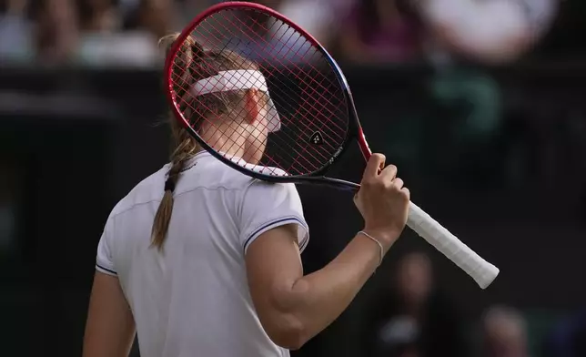 Elena Rybakina of Kazakhstan plays a reacts during her semifinal match against Barbora Krejcikova of the Czech Republic at the Wimbledon tennis championships in London, Thursday, July 11, 2024. (AP Photo/Alberto Pezzali)