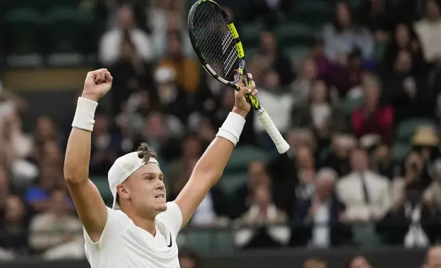 Holger Rune of Denmark celebrates after defeating Quentin Halys France in their third round match at the Wimbledon tennis championships in London, Saturday, July 6, 2024. (AP Photo/Alberto Pezzali)