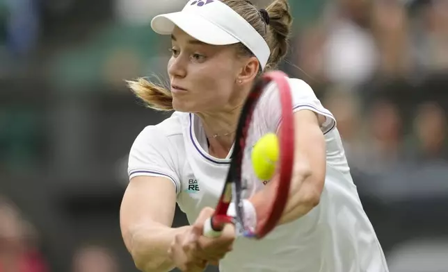 Elena Rybakina of Kazakhstan plays a backhand return to Russia's Anna Kalinskaya during their fourth round match at the Wimbledon tennis championships in London, Monday, July 8, 2024. (AP Photo/Kirsty Wigglesworth)