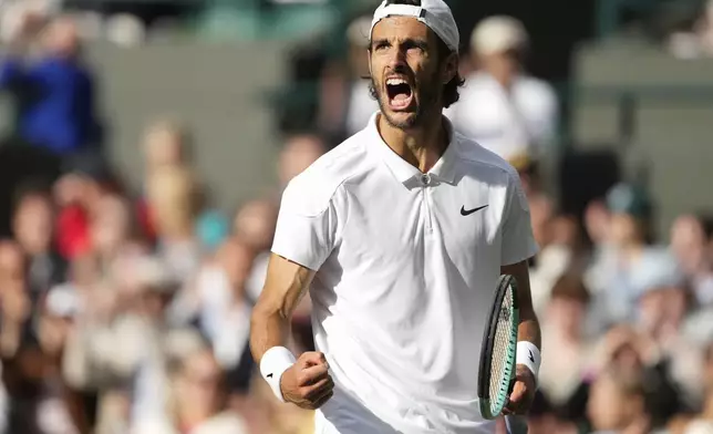 Lorenzo Musetti of Italy reacts after winning a point against Taylor Fritz of the United States during their quarterfinal match at the Wimbledon tennis championships in London, Wednesday, July 10, 2024. (AP Photo/Mosa'ab Elshamy)