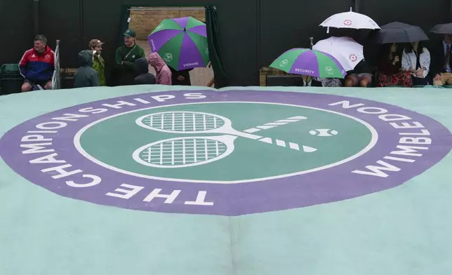 An outside court under a cover as rain delays street to play at the Wimbledon tennis championships in London, Saturday, July 6, 2024.(AP Photo/Kirsty Wigglesworth)