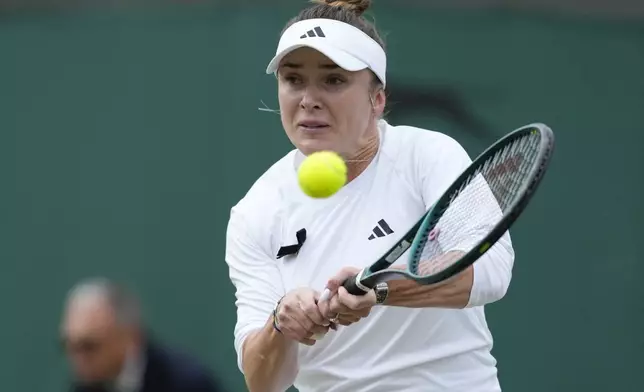 Elina Svitolina of Ukraine plays a backhand return to Xinyu Wang of China during their fourth round match at the Wimbledon tennis championships in London, Monday, July 8, 2024. (AP Photo/Mosa'ab Elshamy)