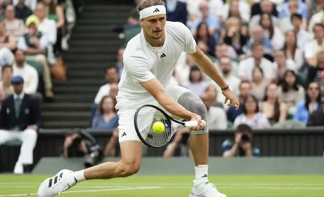 Alexander Zverev of Germany plays a forehand return to Taylor Fritz of the United States during their fourth round match at the Wimbledon tennis championships in London, Monday, July 8, 2024. (AP Photo/Kirsty Wigglesworth)