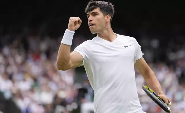 Carlos Alcaraz of Spain reacts after winning a point against Mark Lajal of Estonia during their first round match of the Wimbledon tennis championships in London, Monday, July 1, 2024. (AP Photo/Alberto Pezzali)