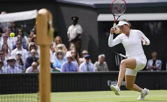 Donna Vekic of Croatia plays a forehand return to Jasmine Paolini of Italy during their semifinal match at the Wimbledon tennis championships in London, Thursday, July 11, 2024. (AP Photo/Alberto Pezzali)