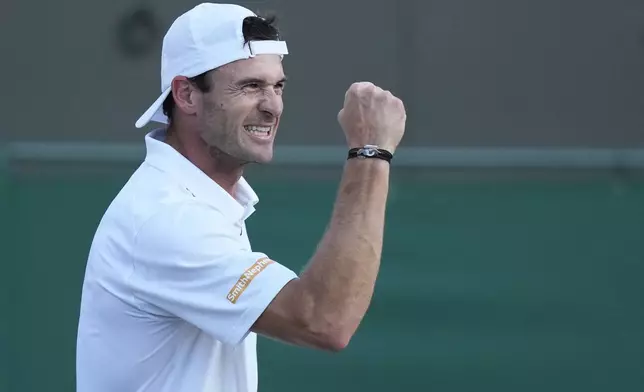 Tommy Paul of the United States celebrates after winning the second set against Roberto Bautista Agut of Spain during their fourth round match at the Wimbledon tennis championships in London, Sunday, July 7, 2024. (AP Photo/Mosa'ab Elshamy)