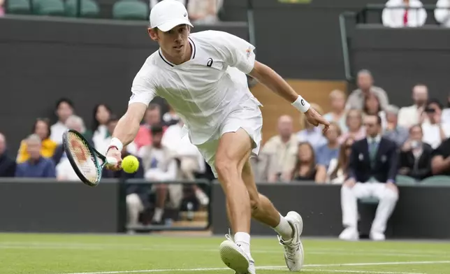 Alex de Minaur of Australia plays a forehand return to Arthur Fils of France during their fourth round match at the Wimbledon tennis championships in London, Monday, July 8, 2024. (AP Photo/Alberto Pezzali)