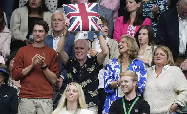 Supporters of Britain's Emma Raducanu react after her win over Elise Mertens of Belgium in their match on day three at the Wimbledon tennis championships in London, Wednesday, July 3, 2024. (AP Photo/Mosa'ab Elshamy)