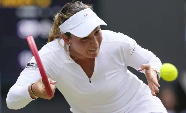 Donna Vekic of Croatia plays a forehand return to Jasmine Paolini of Italy during their semifinal match at the Wimbledon tennis championships in London, Thursday, July 11, 2024. (AP Photo/Alberto Pezzali)