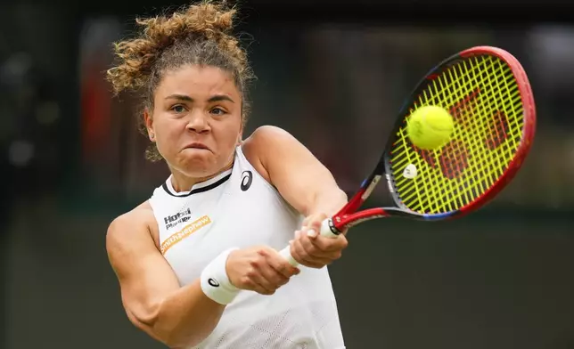 Jasmine Paolini of Italyplays a backhand return to Bianca Andreescu of Canada during their third round match at the Wimbledon tennis championships in London, Friday, July 5, 2024. (AP Photo/Kirsty Wigglesworth)