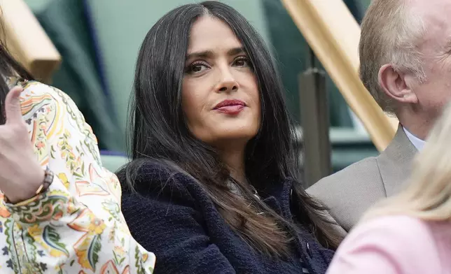 Salma Hayek watches the fourth round match between Carlos Alcaraz of Spain and Ugo Humbert of France on Centre Court at the Wimbledon tennis championships in London, Sunday, July 7, 2024. (AP Photo/Alberto Pezzali)