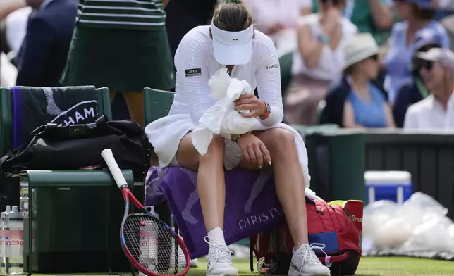 Donna Vekic of Croatia plays places a bag of ice on her wrist during a break in her semifinal against Jasmine Paolini of Italy at the Wimbledon tennis championships in London, Thursday, July 11, 2024. (AP Photo/Alberto Pezzali)