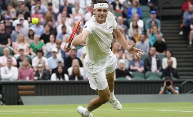 Taylor Fritz of the United States plays a backhand return to Alexander Zverev of Germany during their fourth round match at the Wimbledon tennis championships in London, Monday, July 8, 2024. (AP Photo/Kirsty Wigglesworth)