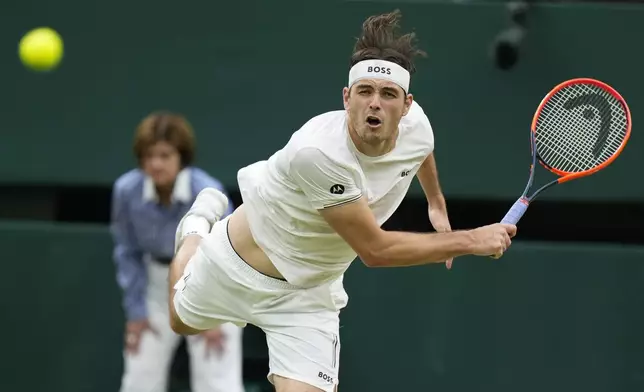 Taylor Fritz of the United States serves to Alexander Zverev of Germany during their fourth round match at the Wimbledon tennis championships in London, Monday, July 8, 2024. (AP Photo/Mosa'ab Elshamy)