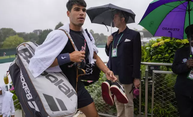Spain's Carlos Alcaraz walks from the courts during a practice session ahead of their first round match of the Wimbledon tennis championships in London, Sunday, June 30, 2024. (AP Photo/Alberto Pezzali)