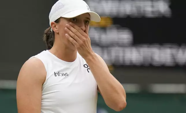 Iga Swiatek of Poland reacts during her third round loss to Yulia Putintseva of Kazakhstan at the Wimbledon tennis championships in London, Saturday, July 6, 2024. (AP Photo/Alberto Pezzali)