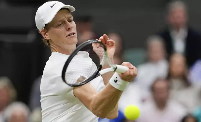 Jannik Sinner of Italy plays a forehand return to Daniil Medvedev of Russia during their quarterfinal match at the Wimbledon tennis championships in London, Tuesday, July 9, 2024. (AP Photo/Alberto Pezzali)