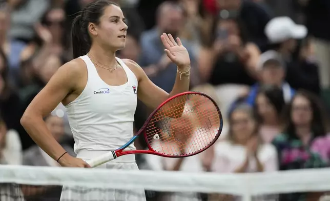 Emma Navarro of the United States waves after defeating Naomi Osaka of Japan in their match on day three at the Wimbledon tennis championships in London, Wednesday, July 3, 2024. (AP Photo/Alberto Pezzali)