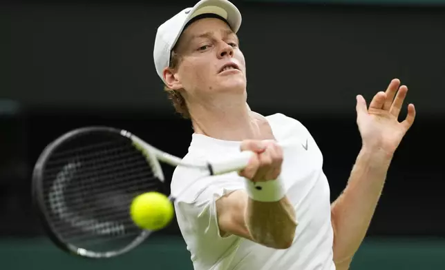 Jannik Sinner of Italy plays a forehand return to Daniil Medvedev of Russia during their quarterfinal match at the Wimbledon tennis championships in London, Tuesday, July 9, 2024. (AP Photo/Alberto Pezzali)