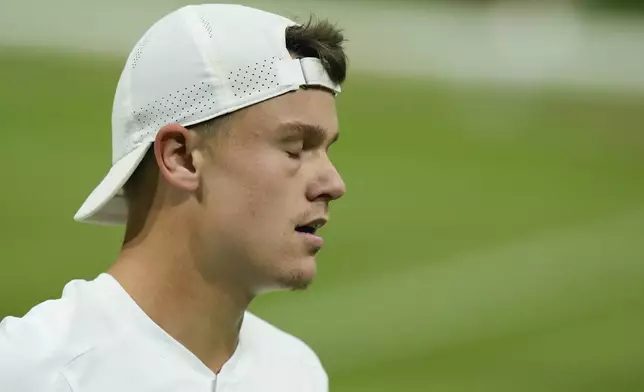 Holger Rune of Denmark reacts during his fourth round match against Novak Djokovic of Serbia at the Wimbledon tennis championships in London, Monday, July 8, 2024. (AP Photo/Mosa'ab Elshamy)