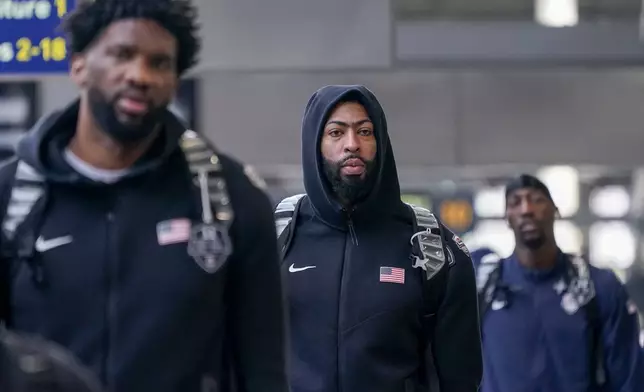 United States' Anthony Davis, centre, arrives at St Pancras Station with teammates, to take the Eurostar train as they make their way to the Olympic Games in Paris, in London, Wednesday, July 24, 2024.(AP Photo/Alberto Pezzali)