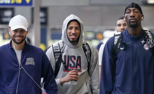 United States' Steph Curry, left, Tyrese Haliburton, centre, and Bam Adebayo, arrive at St Pancras Station with teammates, to take the Eurostar train as they make their way to the Olympic Games in Paris, in London, Wednesday, July 24, 2024.(AP Photo/Alberto Pezzali)