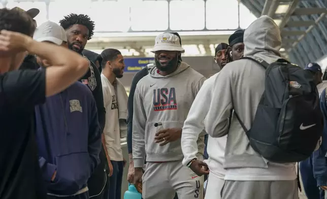 United States' LeBron James, centre, arrives at St Pancras Station with teammates, to take the Eurostar train as they make their way to the Olympic Games in Paris, in London, Wednesday, July 24, 2024.(AP Photo/Alberto Pezzali)