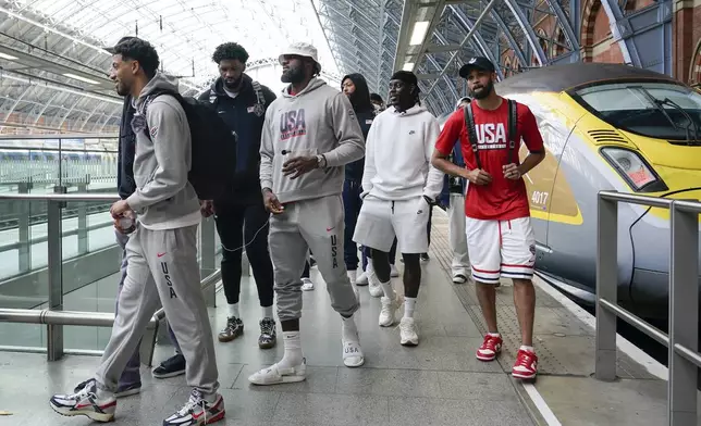 The United States Men's National Basketball Team arrive at St Pancras Station with teammates, to take the Eurostar train as they make their way to the Olympic Games in Paris, in London, Wednesday, July 24, 2024.(AP Photo/Alberto Pezzali)