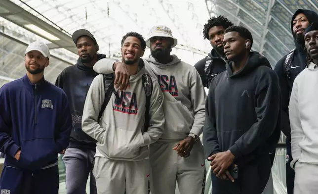 The United States Men's National Basketball Team pose for photographs at St Pancras Station with teammates as they take the Eurostar train as they make their way to the Olympic Games in Paris, in London, Wednesday, July 24, 2024.(AP Photo/Alberto Pezzali)