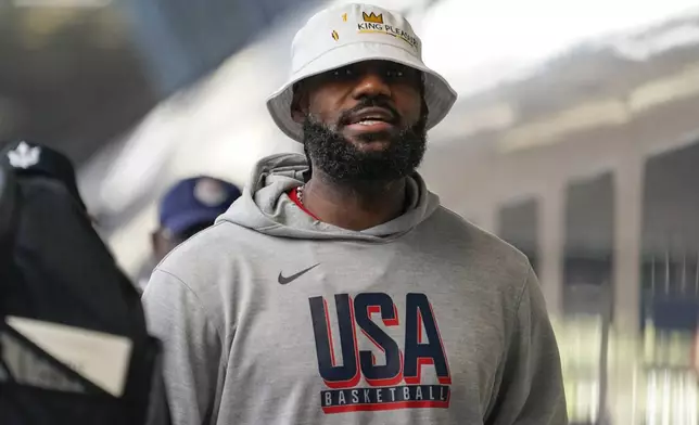 United States' LeBron James arrives at St Pancras Station with teammates, to take the Eurostar train as they make their way to the Olympic Games in Paris, in London, Wednesday, July 24, 2024.(AP Photo/Alberto Pezzali)